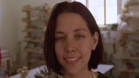 young female potter working in her studio