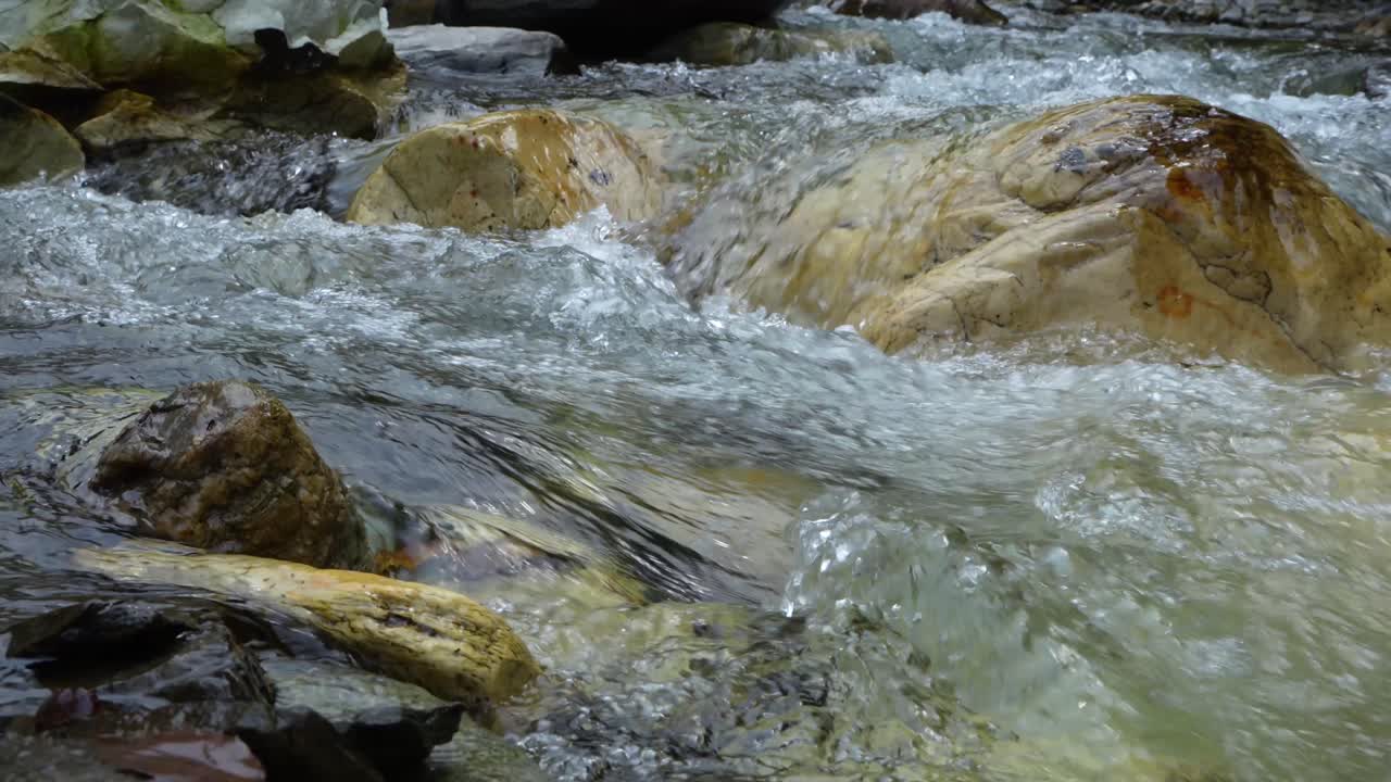 L'acqua scorre attraverso un fiume montano torrenziale
