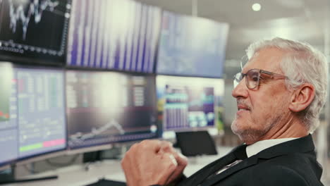 mature businessman looking at charts, smiling