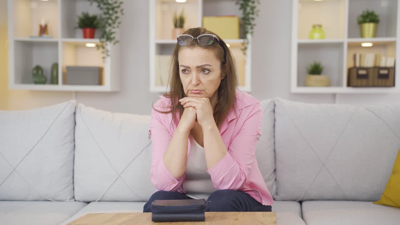 Empty wallet and depressed woman.