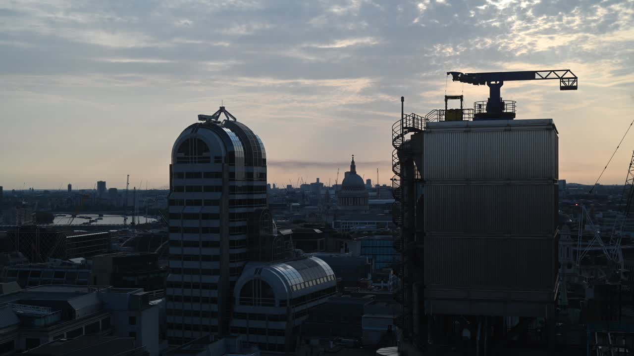 Evening view of St Paul's Cathedral through the Lloyd's of London Building, London, United Kingdom