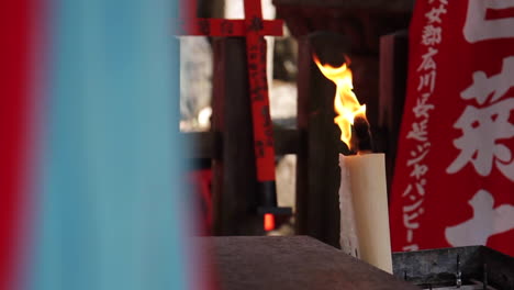 candle burns in buddhist temple nara park osaka japan