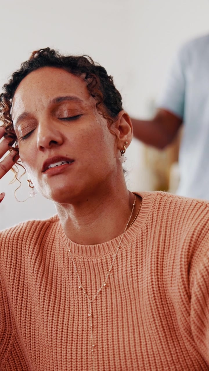 Woman Meditating with Eyes Closed in a Calm Indoor Setting