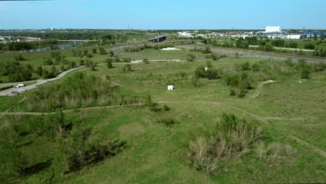 Aerial-shot-unveiling-traffic-circles,-exits,-and-highway-in-summertime,-Calgary,-Alberta