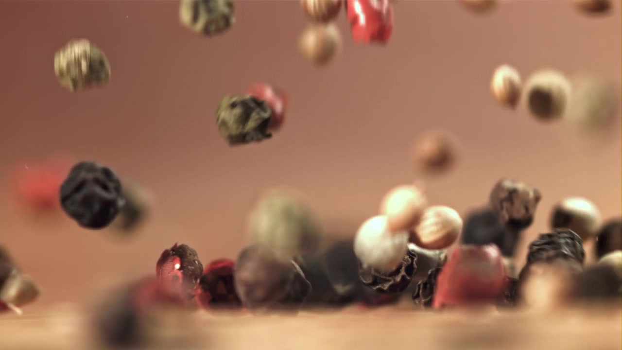 Mixed Peppercorns Falling in Slow Motion