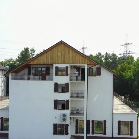 man drinking coffee at balcony
