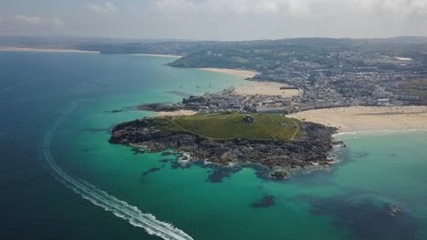 Motorboat-travelling-through-Cornwall-coastal-waters,-St-Ives-UK,-aerial-view