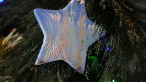 hand made christmas star decoration hanging in a christmas tree