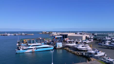 rising tilt drone shot of boats and yachts at fremantle harbour, perth, western australia