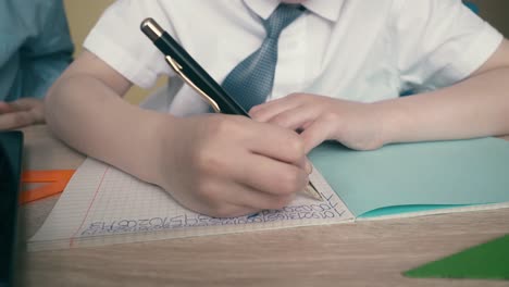 Slow-motion-Schoolchildren-do-homework-write-numbers-in-notebook