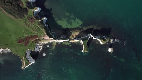 Birds-Eye-View-of-Kayaks-and-Chalk-Cliff-Erosion-at-Old-Harry-Rocks,-Jurassic-Coast,-England