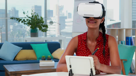 female graphic designer in virtual reality headset using digital tablet at desk 4k