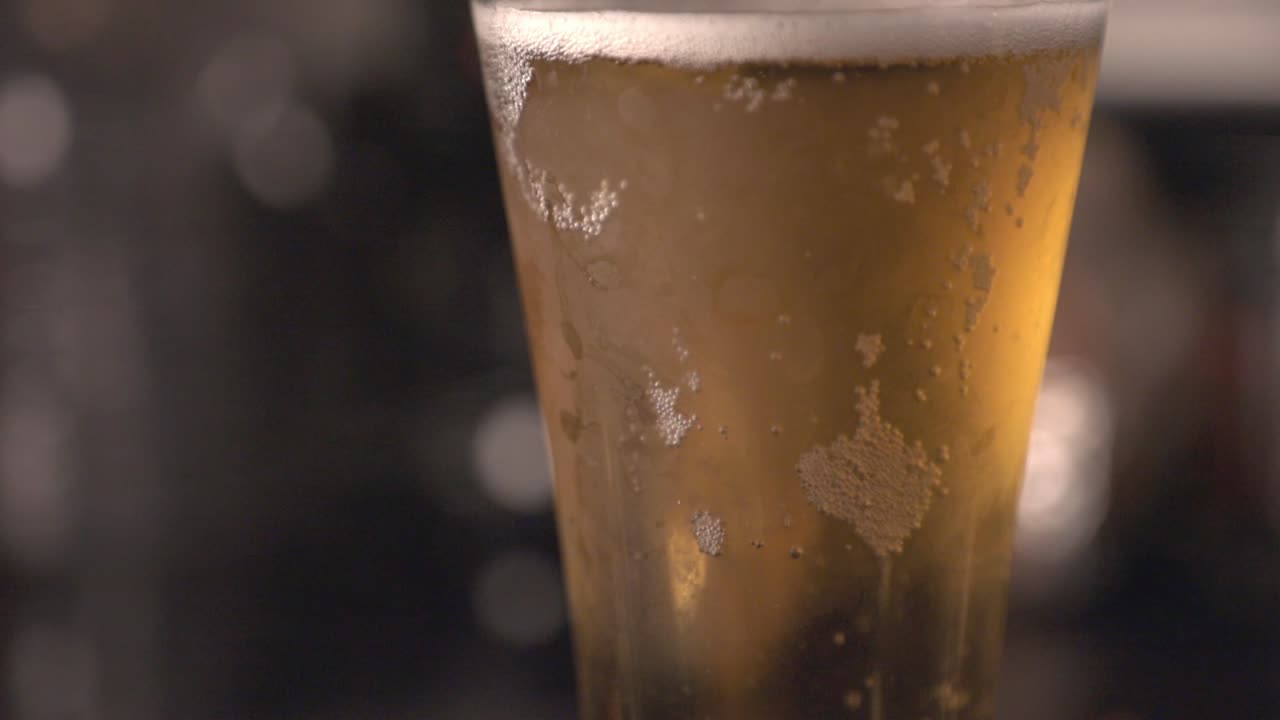 A Glass Of Ice Cold Beer On The Bar Counter. - close up shot