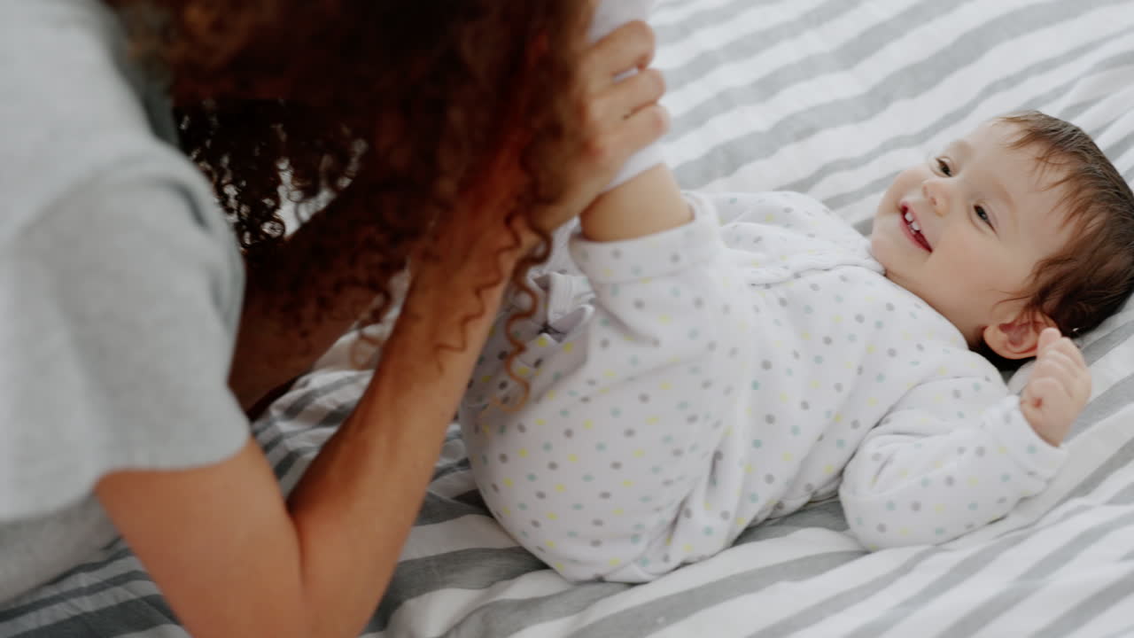Cucù, gioco e madre con bambino su un letto