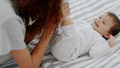 Peekaboo,-game-and-mother-with-child-on-a-bed