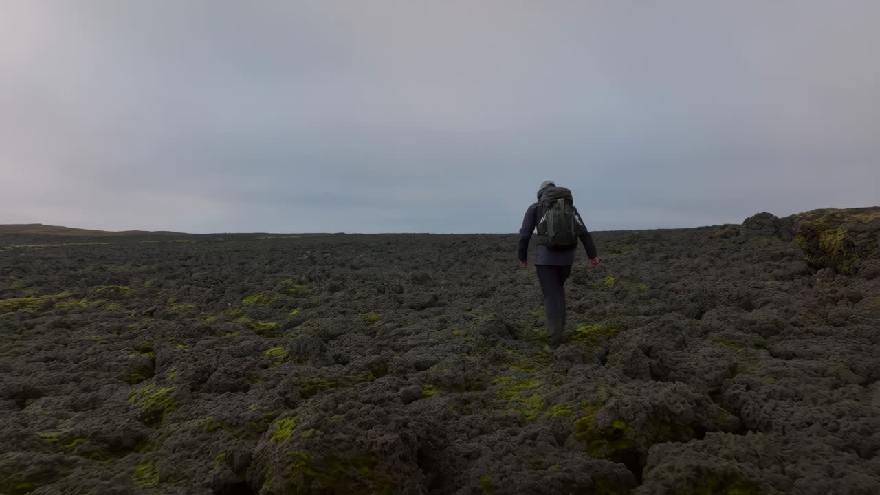 Person hiking in a lava field
