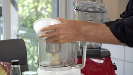 adding walnuts to blender to make a crust for homemade dairy-free vegan plant based cheesecake diet healthy eating