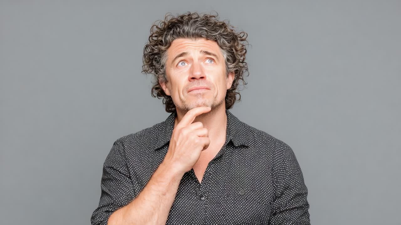 A man deep in thought, displaying a contemplative expression while pondering, showing curiosity and interest in the concepts swirling in his mind