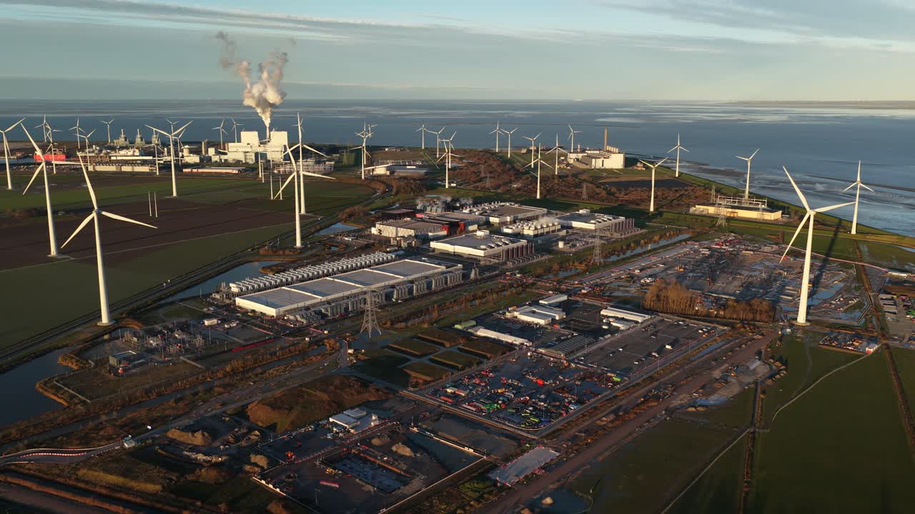 High altitude aerial drone view of a massive hyperscale data center complex in Eemshaven, Netherlands. Core infrastructure for Cloud Computing, Big Data, and global internet connectivity