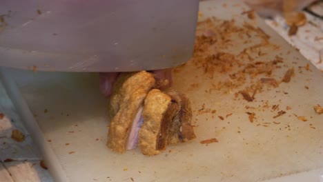 mercado de comida callejera cortando carne de cerdo frita asiática