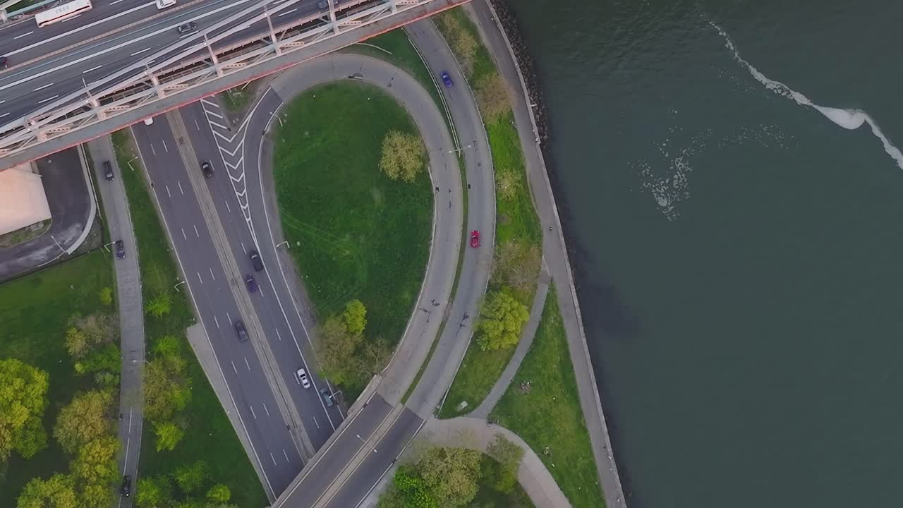 Aerial view of a road with cars and green spaces