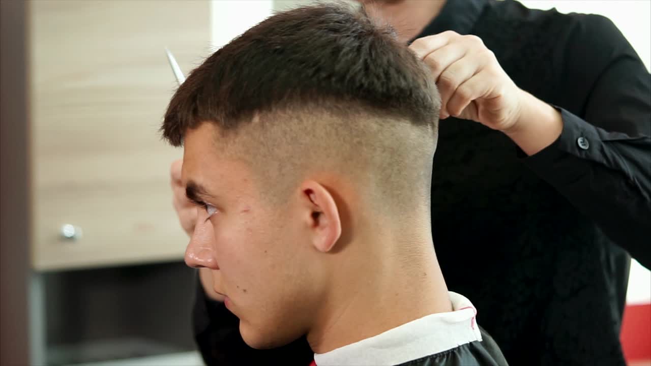 Man getting a short haircut at the barber shop