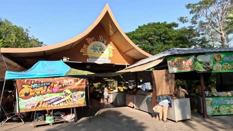 visitors browsing stalls at a sunny outdoor market