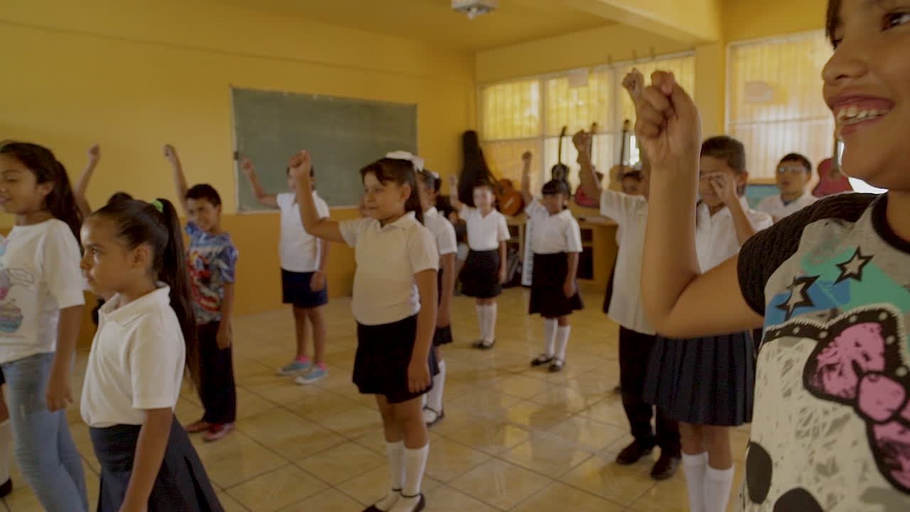 Children in a classroom participating in a physical activity