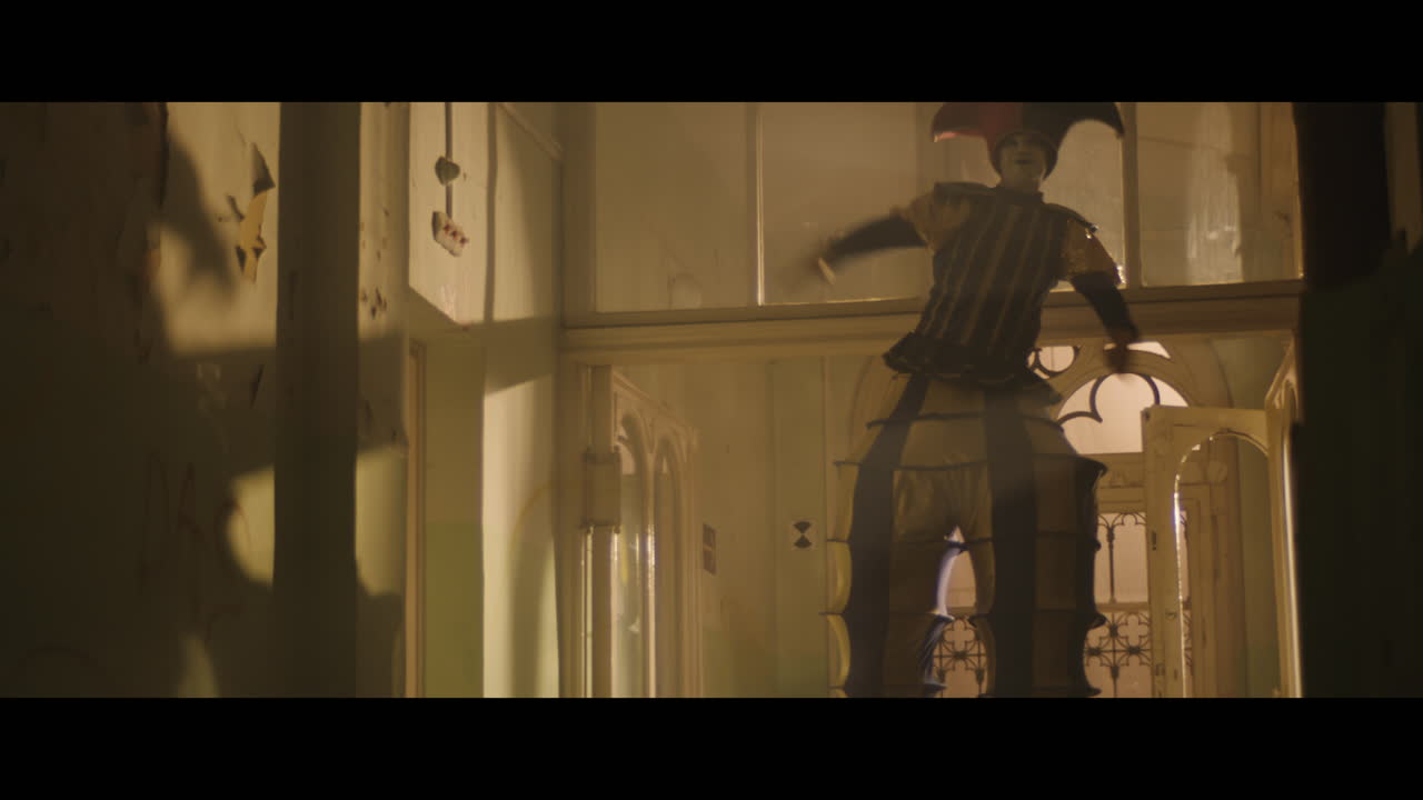 A girl and strange clown on stilts in a dark corridor at night