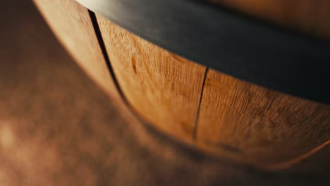 closeup macro shot of a whiskey or wine barrel as the camera pushes down the barrel