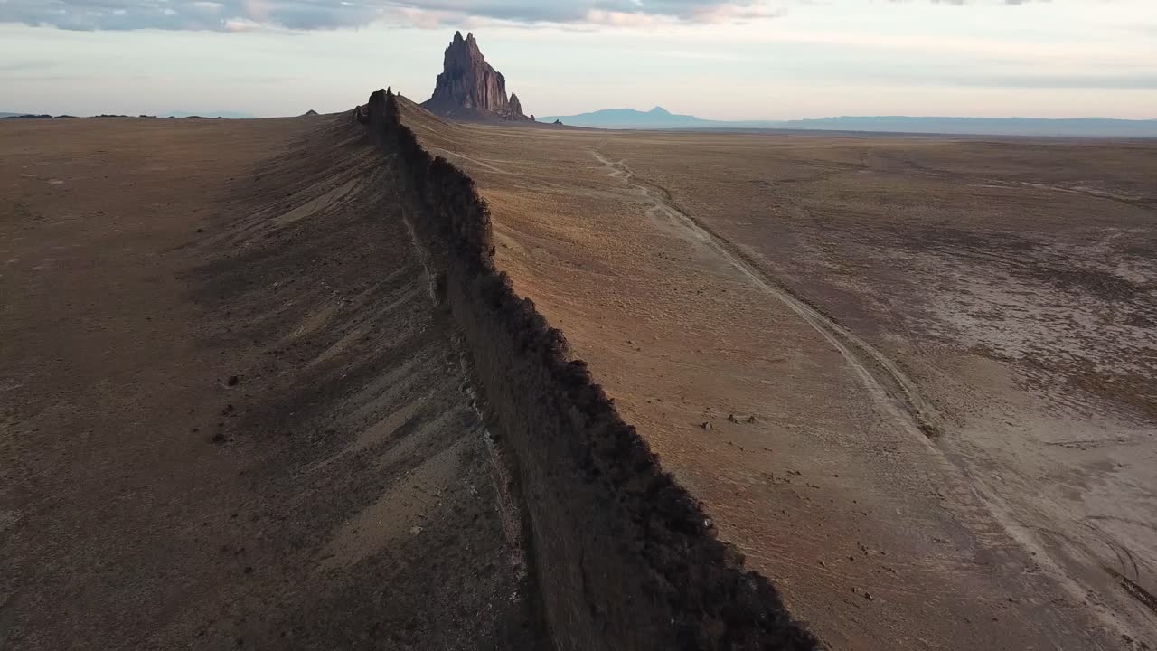 4k Aerial flight going around rock formation dike in New Mexico