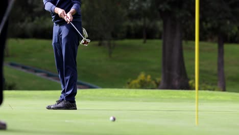 foot of golfer with putting golf ball