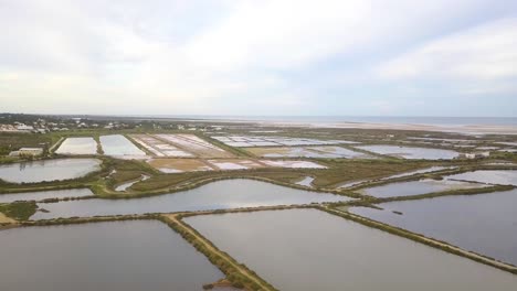 wide panoramic aerial over the salt pans and beaches of fuseta on the algarve portugal