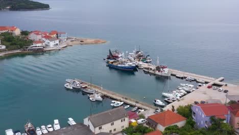 fishing trawler and boats moored on the marina of kali by adriatic sea in croatian island of ugljan