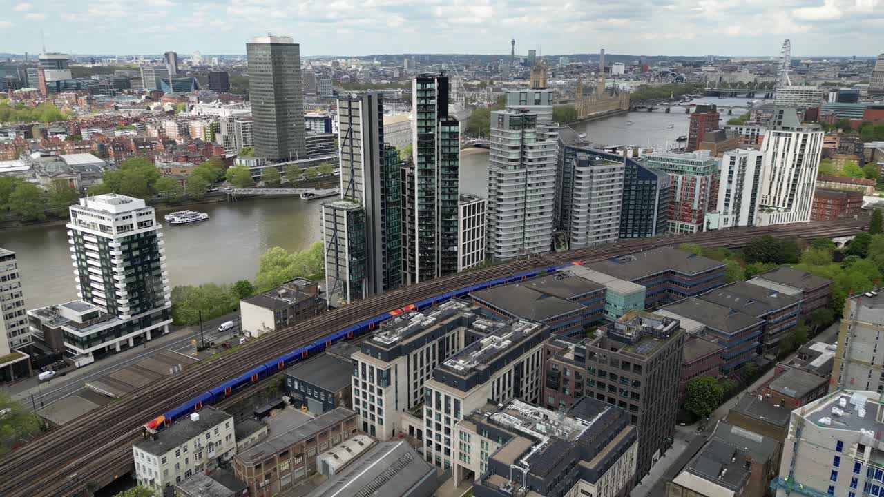 Calm 4K drone shot capturing a train passing through the city of London. Slow motion capable, perfect for travel, urban, transportation, or cinematic projects