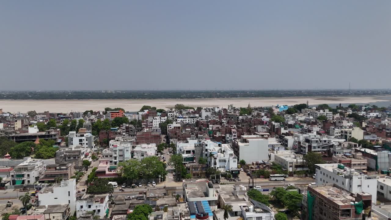 High-altitude footage capturing the sprawling, chaotic energy of Varanasi, where the sacred and the mundane blend in a vibrant dance of life.