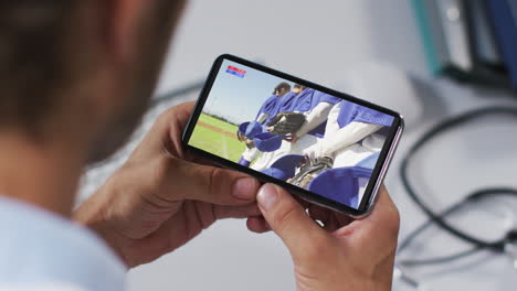 composite of male doctor watching baseball game on smartphone