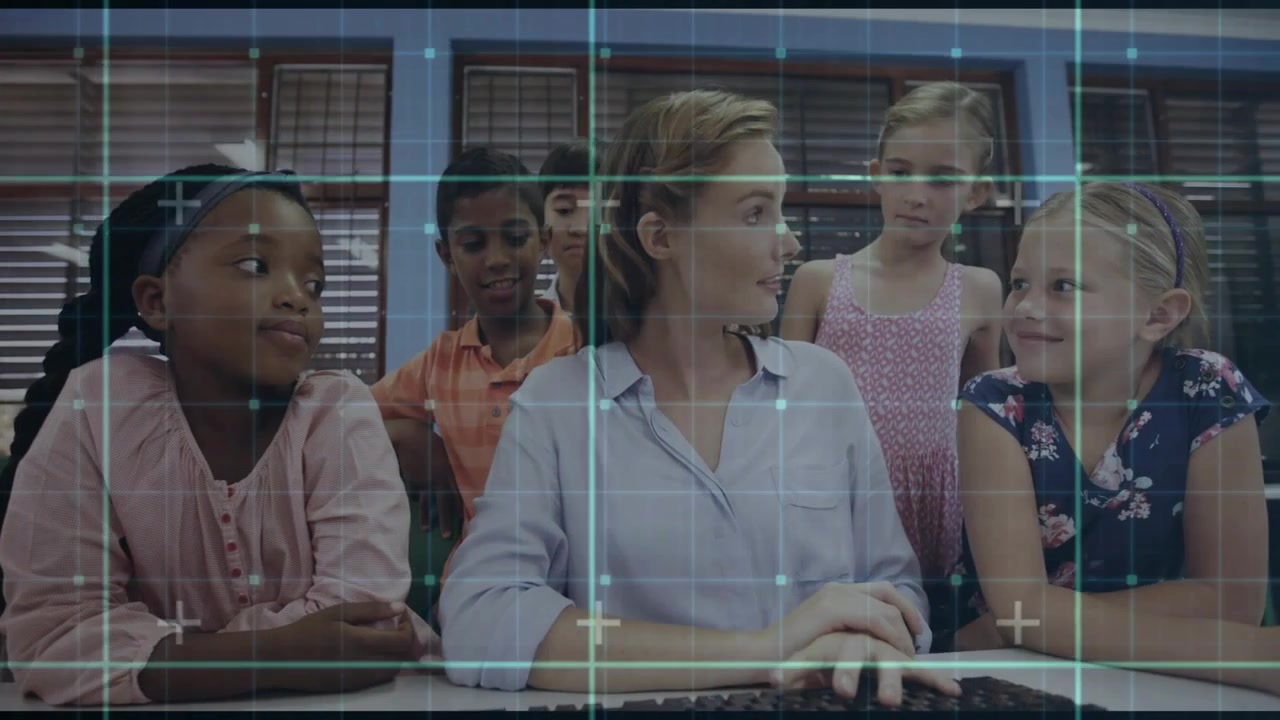 HUD overlay appearing, teacher touching keyboard and typing while addressing children for demo