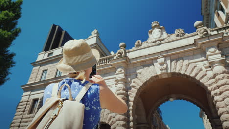 the tourist photographs a famous arch near the parliament in stockholm tourism in scandinavia concep