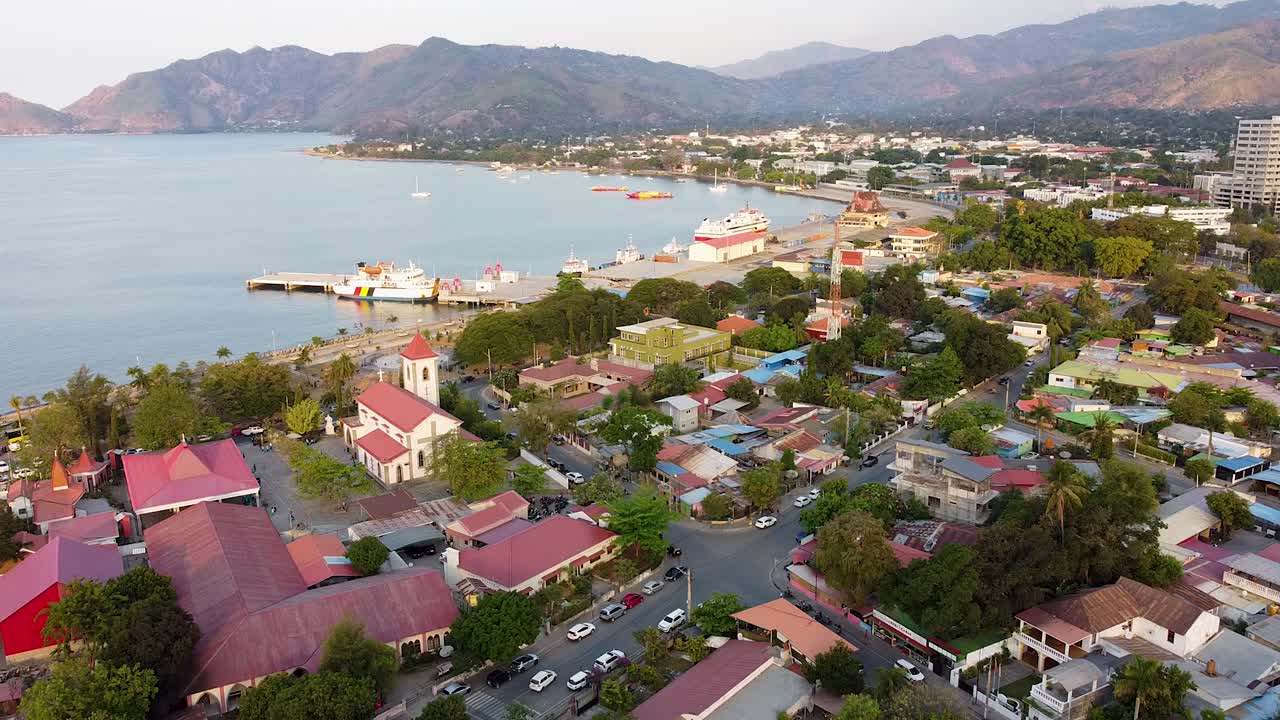 Static aerial view over capital city of Dili, Timor-Leste in Southeast Asia, with houses, buildings, and ocean