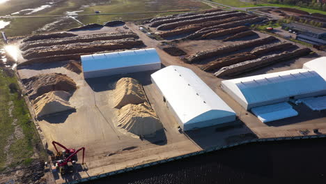 aerial view of lumber export at pärnu port with log piles and warehouses