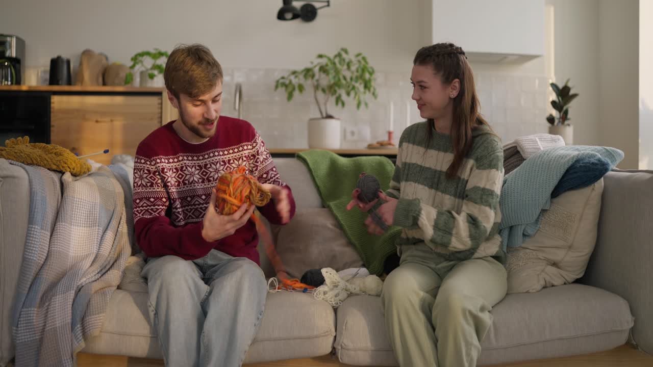 Couple Knitting Together on a Couch