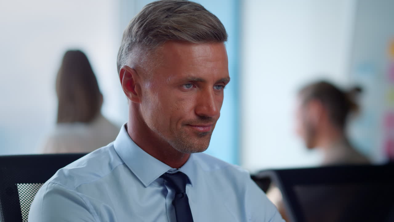 Businessman sitting at workplace in office. Male executive waving head no