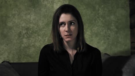 Beautiful-woman-in-grungy-room-looks-around-looking-worried