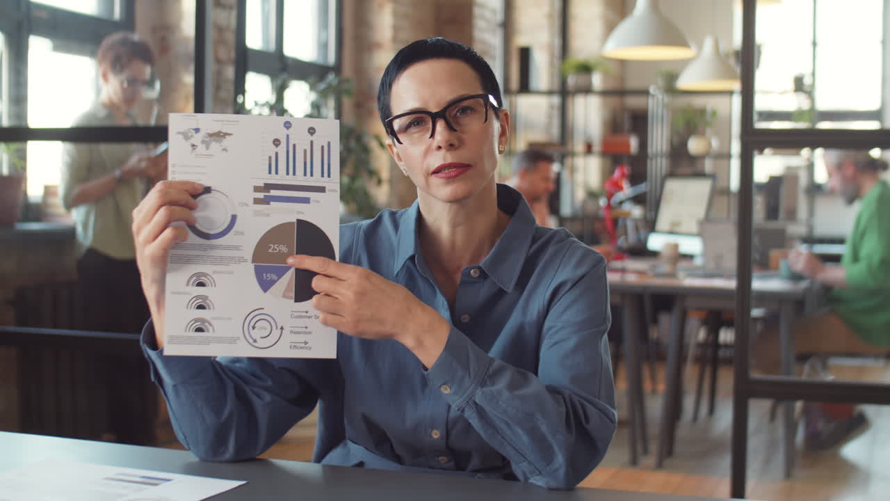 Businesswoman Presenting Data Analysis in Office