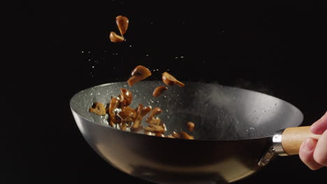 cooking mushrooms in a wok