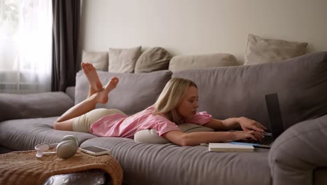 young woman working from home on a couch