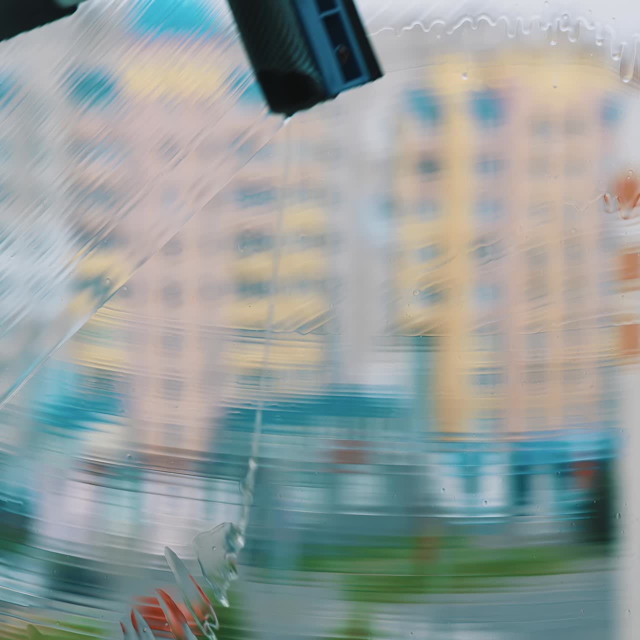 Close up view of cleaning window. Window cleaner working with wet glass window