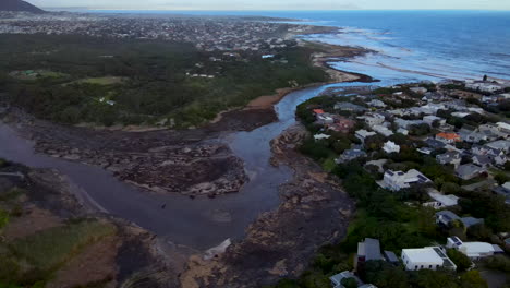 High-angle-aerial-view-showing-aftermath-of-extreme-flooding-with-river-debris