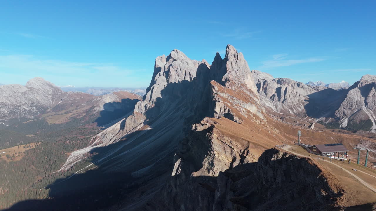 Drone pullback reveals chairlift (Seggiovia Fermeda) on Seceda Ridgeline